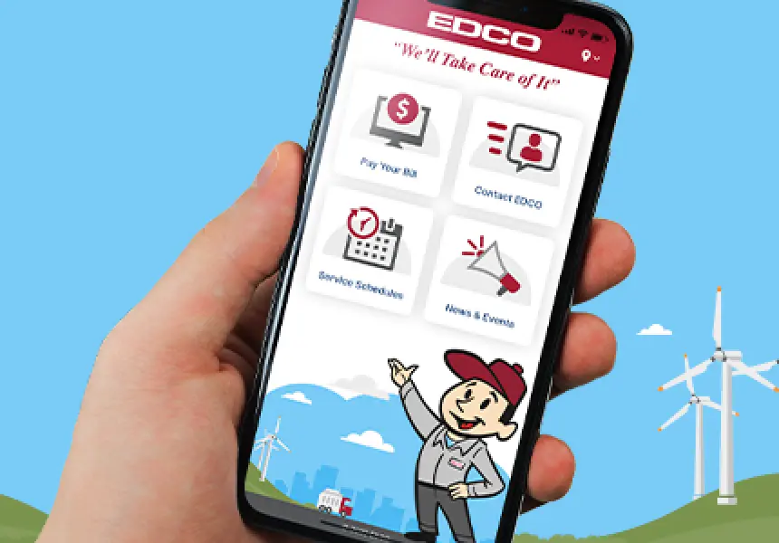 Illustration of EDCO's mascot character in the background and hand holding mobile phone with EDCO website in the foreground